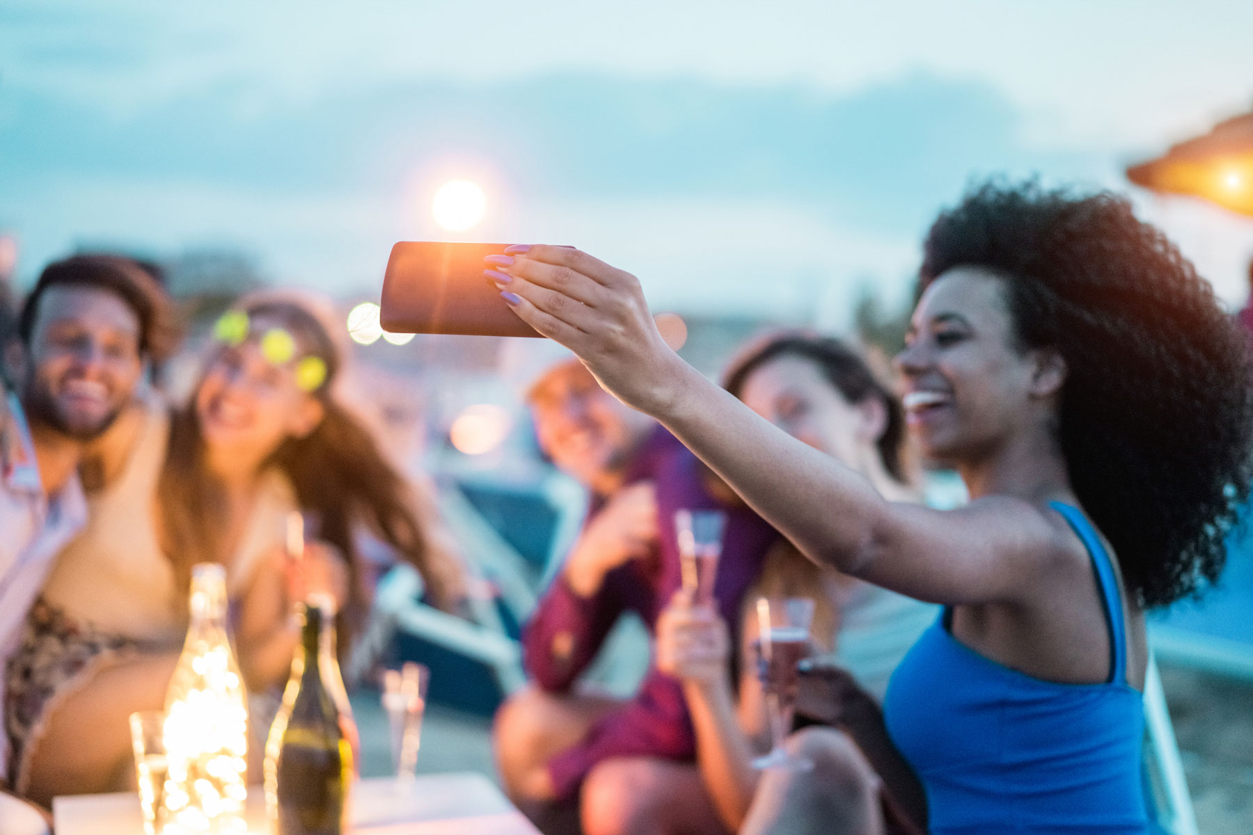 group of friends sipping champagne taking selfies